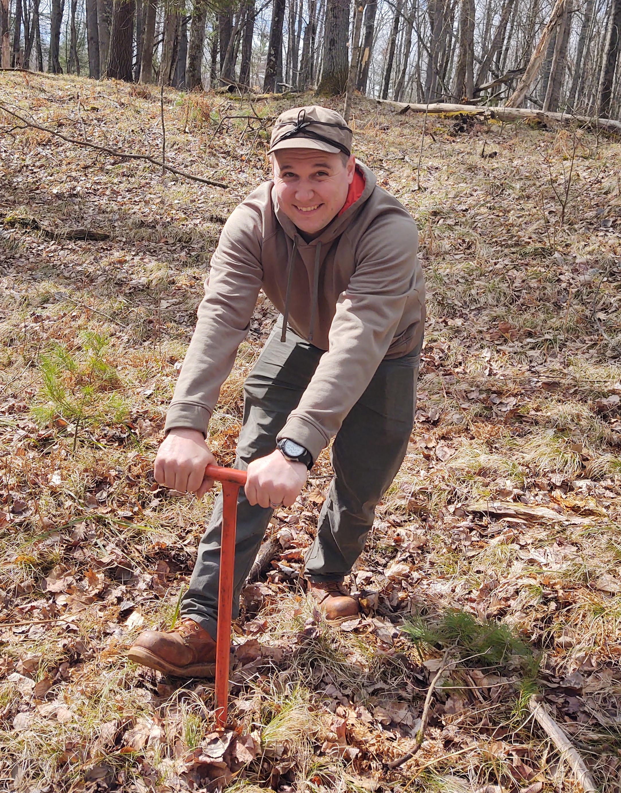 Joe Malinowski preparing to plant a tree.