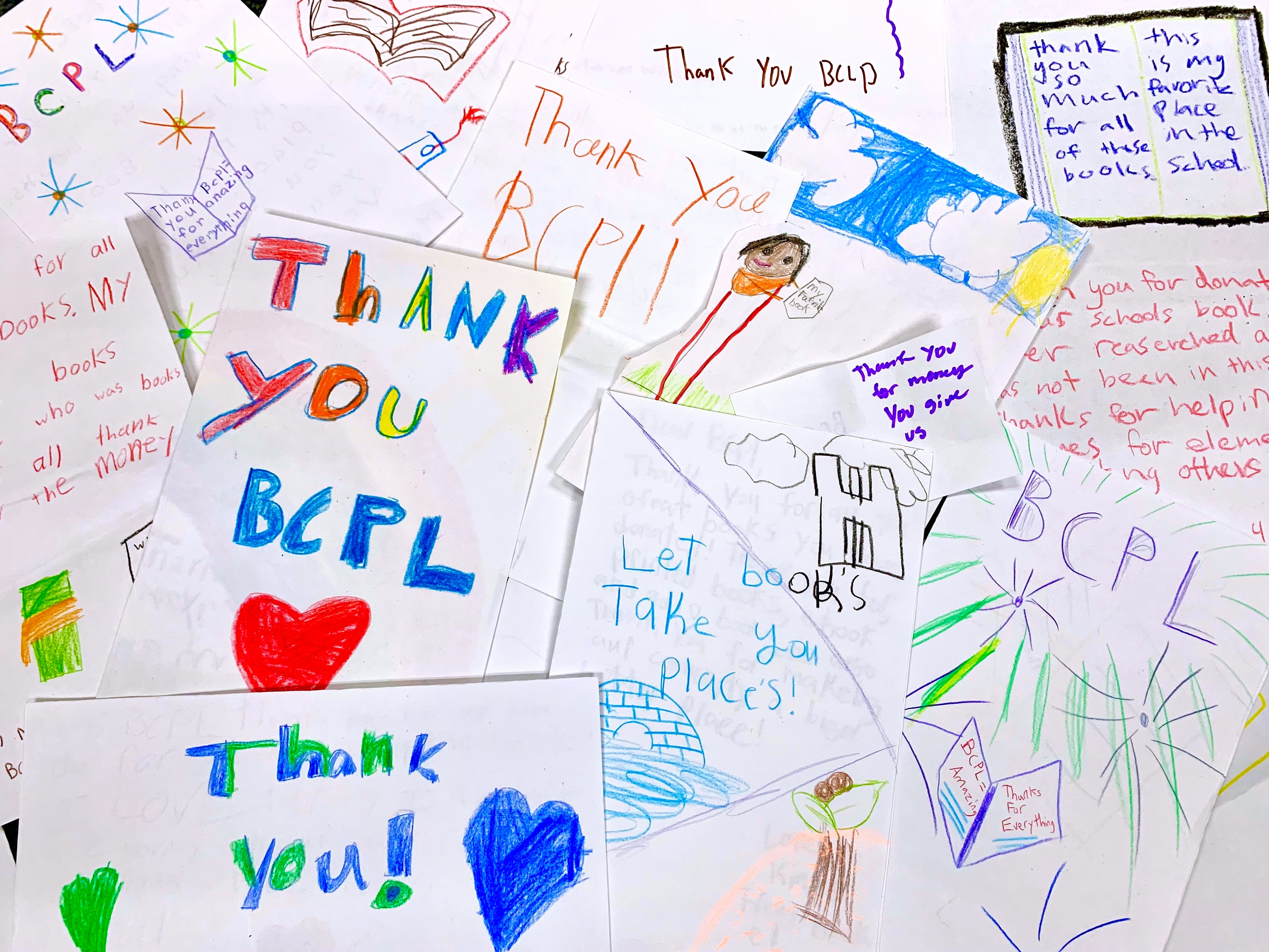 2021-2023 Biennial report cover with hand drawn notes from school children taht benfit from  library aid distrbutons