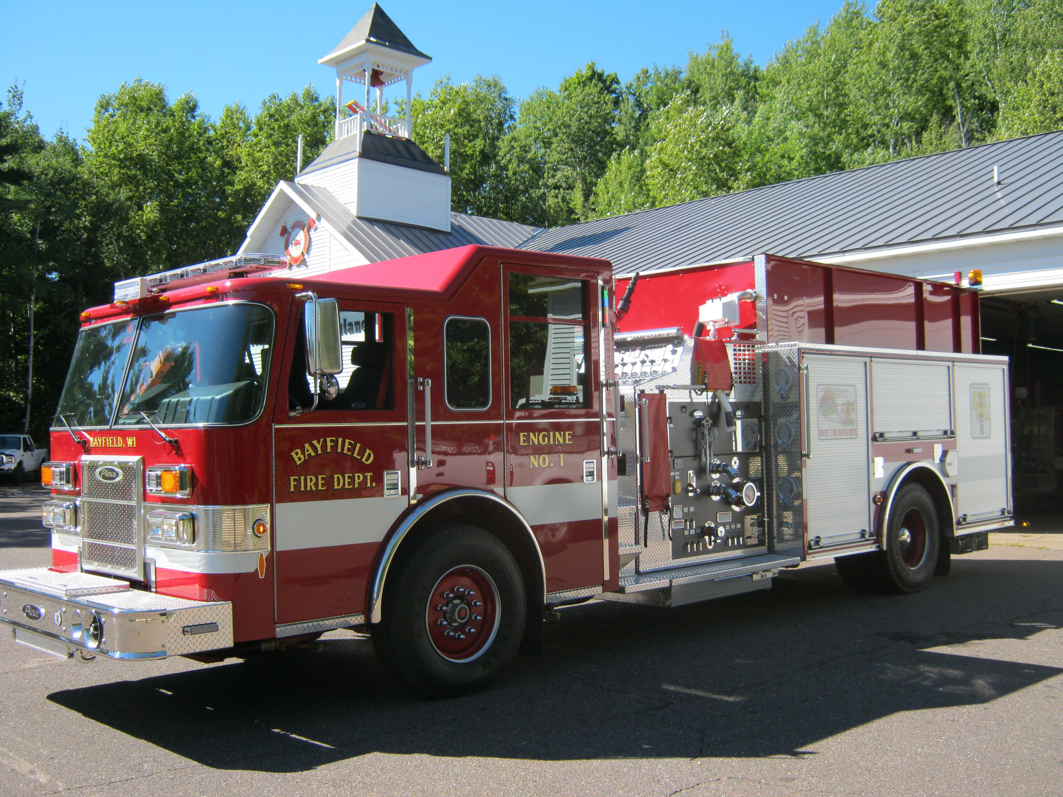 Drivers side image of Bayfield's fire department Engine #1 with red and white paint with gold lettering.