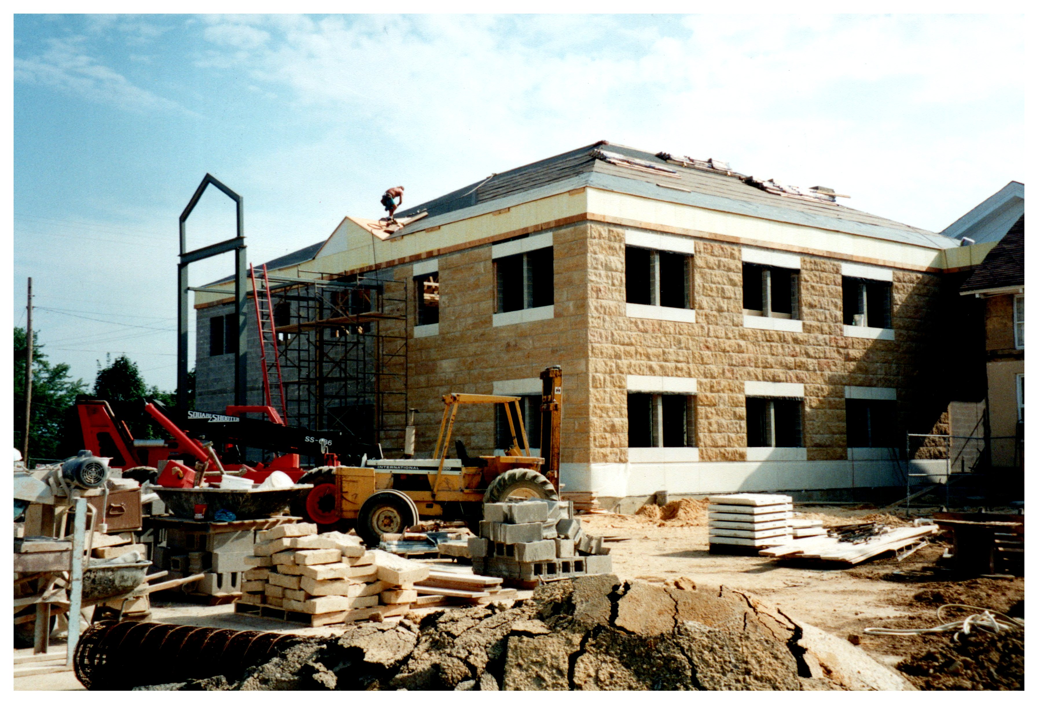 Two story stone county court house being roofed in Iowa County. 
