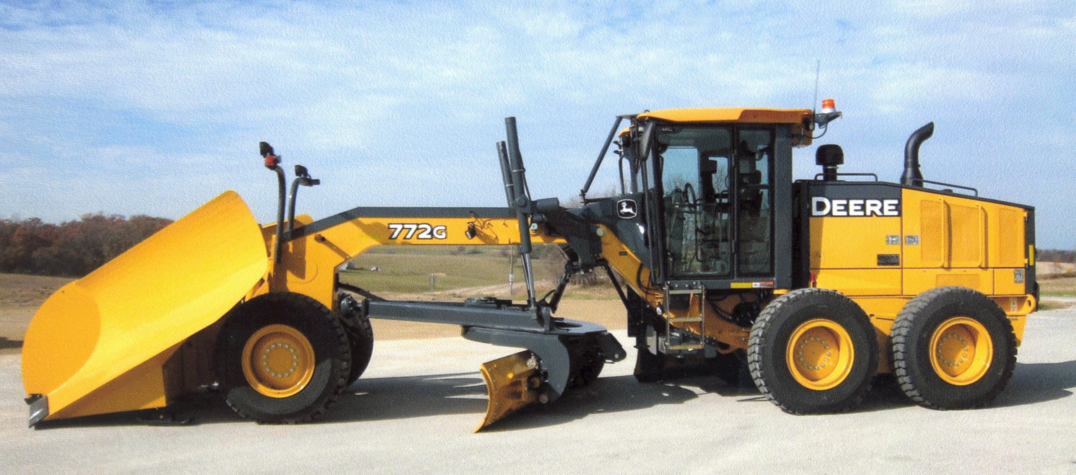 Side profile of a large yellow John Deere road grader in the Town of Christiania